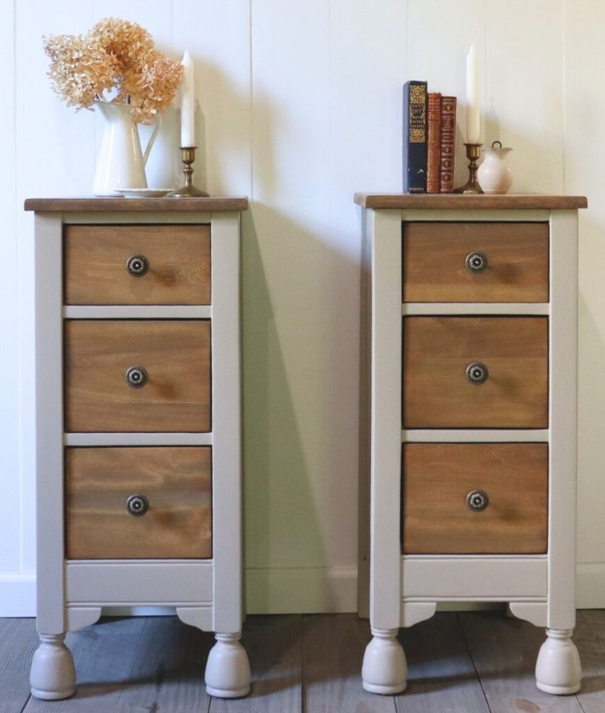 Two greige and brown vintage nightstands against a white wall with vintage decor on top